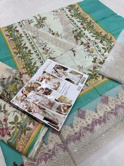 Patterned fabric with a magazine on top, featuring floral and geometric designs.